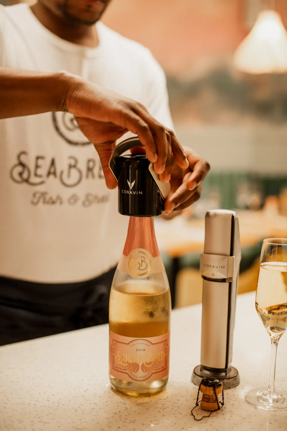 A SeaBreeze server pouring sparkling wine