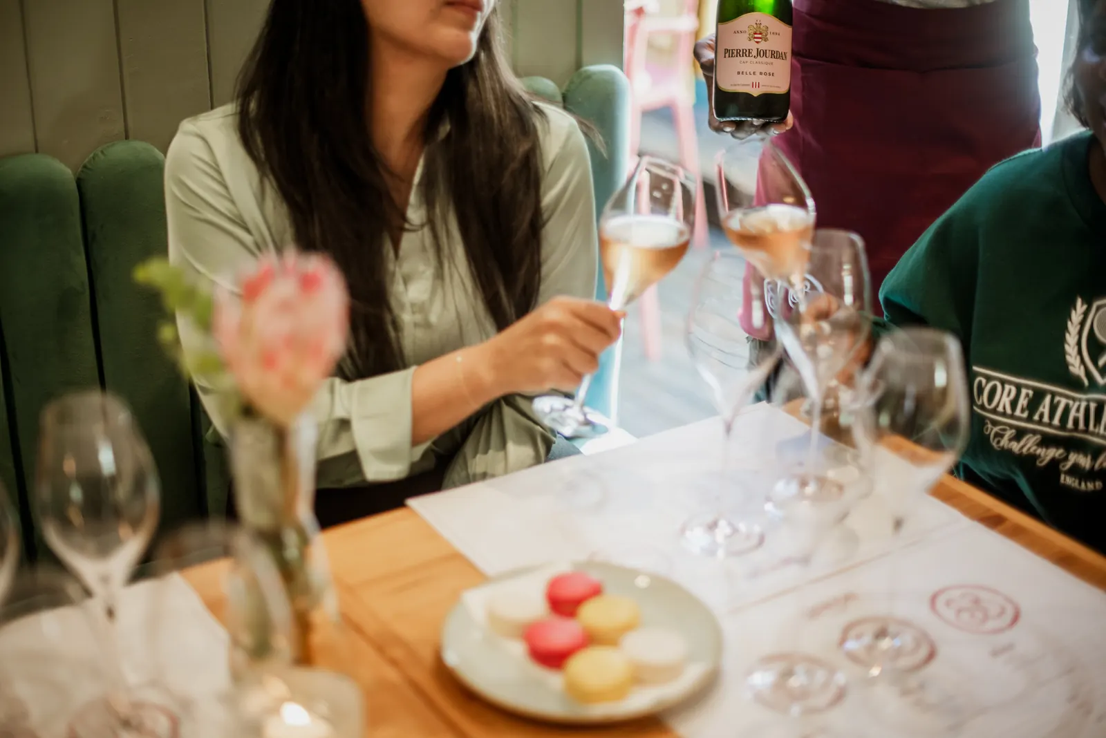 Guests enjoying a Cap Classique tasting with macarons